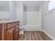 Bathroom featuring a combination shower and tub with dark wood vanity at 238 Howell Sw Dr, Atlanta, GA 30331