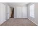 Spacious carpeted bedroom with closet and view of stairs at 238 Howell Sw Dr, Atlanta, GA 30331