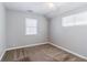 Neutral bedroom with carpet and two windows at 238 Howell Sw Dr, Atlanta, GA 30331
