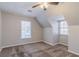 Neutral-colored bedroom featuring soft carpet, natural light from the windows, and a ceiling fan at 238 Howell Sw Dr, Atlanta, GA 30331