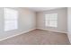 Cozy bedroom with neutral carpet, two windows, and ample natural light at 238 Howell Sw Dr, Atlanta, GA 30331
