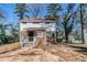 Two-story home featuring a brick and siding exterior with a small front porch and mature trees around the yard at 238 Howell Sw Dr, Atlanta, GA 30331