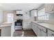 Traditional kitchen features white cabinetry, stainless steel appliances and wood-look vinyl floors at 238 Howell Sw Dr, Atlanta, GA 30331