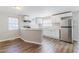 Efficient kitchen featuring white cabinetry, stainless steel appliances, and laminate floors at 238 Howell Sw Dr, Atlanta, GA 30331