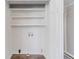 A bright laundry room with shelving, tiled floors and washer/dryer hookups at 238 Howell Sw Dr, Atlanta, GA 30331