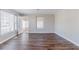 Spacious living room featuring laminate flooring, neutral colors, and ample sunlight at 238 Howell Sw Dr, Atlanta, GA 30331