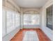 Charming sunroom featuring brick walls, tile flooring, and abundant natural light at 238 Howell Sw Dr, Atlanta, GA 30331
