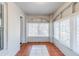 Bright sunroom featuring large windows, tile flooring, and neutral paint at 238 Howell Sw Dr, Atlanta, GA 30331