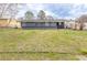 Backyard view with grass and a blue house at 2631 Santa Barbara Nw Dr, Atlanta, GA 30318