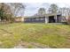 Backyard with grass, trees, and a blue house at 2631 Santa Barbara Nw Dr, Atlanta, GA 30318