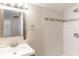 Bathroom featuring tile shower with decorative accent and modern vanity at 2631 Santa Barbara Nw Dr, Atlanta, GA 30318