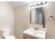 Bathroom with a single vanity, toilet, mirror, vanity lighting and towel bar at 2631 Santa Barbara Nw Dr, Atlanta, GA 30318