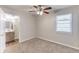 Cozy bedroom with carpet flooring, ceiling fan, a window with blinds and ensuite bathroom at 2631 Santa Barbara Nw Dr, Atlanta, GA 30318