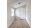 Cozy bedroom with neutral carpet, white walls, and an exterior door at 2631 Santa Barbara Nw Dr, Atlanta, GA 30318