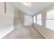 Bright bedroom featuring neutral carpet, white walls, and a door to the hallway at 2631 Santa Barbara Nw Dr, Atlanta, GA 30318
