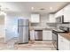 Bright kitchen featuring stainless steel appliances, granite counters, and white cabinets, complemented by wood-look flooring at 2631 Santa Barbara Nw Dr, Atlanta, GA 30318