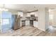 Bright kitchen with stainless steel appliances, granite counters, white cabinetry, and wood-look floors at 2631 Santa Barbara Nw Dr, Atlanta, GA 30318