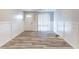 Spacious living room features wood-look flooring, wainscoting, sliding glass doors to let in natural light at 2631 Santa Barbara Nw Dr, Atlanta, GA 30318