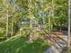 An aerial view shows a charming home nestled among mature trees and a private driveway at 275 Waverly W Trce, Roswell, GA 30075
