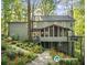 A charming backyard features a screened porch, deck, and vibrant landscaping with a stone path at 275 Waverly W Trce, Roswell, GA 30075