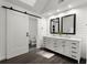 Bathroom with a double vanity, shiplap walls, wood floors, and a view to the toilet at 275 Waverly W Trce, Roswell, GA 30075