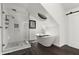 Bright bathroom with a glass shower, soaking tub, and a black sliding barn door at 275 Waverly W Trce, Roswell, GA 30075