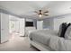 A spacious bedroom with a ceiling fan and carpeted floor with an open doorway to the bathroom at 275 Waverly W Trce, Roswell, GA 30075