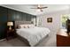 Bedroom with a dark green accent wall, lamps, windows, and a television at 275 Waverly W Trce, Roswell, GA 30075