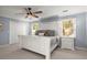 Spacious bedroom featuring light blue walls, carpeted floors, a ceiling fan, and white furniture at 275 Waverly W Trce, Roswell, GA 30075