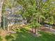 An elevated two-story home with charming front porch surrounded by lush landscaping at 275 Waverly W Trce, Roswell, GA 30075