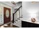 Inviting foyer with a decorative wooden door and a view of the staircase at 275 Waverly W Trce, Roswell, GA 30075