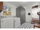 Well-lit laundry room featuring a large window and modern washer and dryer at 275 Waverly W Trce, Roswell, GA 30075