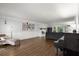 Open-concept living room with hardwood floors, a fireplace, and plenty of natural light at 275 Waverly W Trce, Roswell, GA 30075