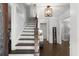Elegant staircase with hardwood steps and white railings, leading to the upper level at 275 Waverly W Trce, Roswell, GA 30075