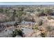 Aerial view of townhomes surrounded by lush trees at 312 River Glen Dr, Roswell, GA 30075