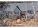 Aerial view of a brick home with a gray roof and mature trees at 312 River Glen Dr, Roswell, GA 30075