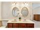 Bathroom features a double sink vanity with oval mirrors and modern lighting fixtures at 312 River Glen Dr, Roswell, GA 30075