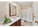 Well-maintained bathroom features a vanity, mirror, and shower with white curtain at 312 River Glen Dr, Roswell, GA 30075