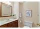 Well-lit bathroom features a vanity with a mirror and a toilet at 312 River Glen Dr, Roswell, GA 30075