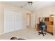 Bright bedroom with neutral carpet, closet, and a wooden desk with chair at 312 River Glen Dr, Roswell, GA 30075