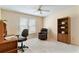 Comfortable bedroom features a ceiling fan, recliner, and a bookshelf at 312 River Glen Dr, Roswell, GA 30075