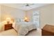 Well lit bedroom features a ceiling fan, bed, and neutral carpet at 312 River Glen Dr, Roswell, GA 30075
