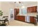 Modern kitchen featuring stainless steel appliances, granite countertops, and seamless flow to the dining and living areas at 312 River Glen Dr, Roswell, GA 30075