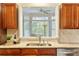 Stylish kitchen featuring stainless steel appliances, granite countertops, with a pass through to the cozy living room at 312 River Glen Dr, Roswell, GA 30075