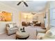 Spacious living room with plush seating, neutral decor, and multiple ceiling fans, creating a welcoming atmosphere at 312 River Glen Dr, Roswell, GA 30075