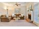Comfortable living room featuring a brick fireplace, neutral tones, ceiling fan, and a sliding glass door to the exterior at 312 River Glen Dr, Roswell, GA 30075