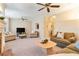 Spacious living room with plush seating, neutral decor, brick fireplace, and multiple ceiling fans, creating a warm atmosphere at 312 River Glen Dr, Roswell, GA 30075