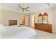 Bright main bedroom boasts a trey ceiling, ceiling fan and views of the home at 312 River Glen Dr, Roswell, GA 30075