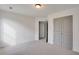 An airy bedroom features neutral carpet, a double door closet, and a bright overhead light at 4315 Easter Lily Ave, Buford, GA 30519