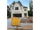 New construction featuring a two-car garage and classic white siding with black roof accents at 4315 Easter Lily Ave, Buford, GA 30519